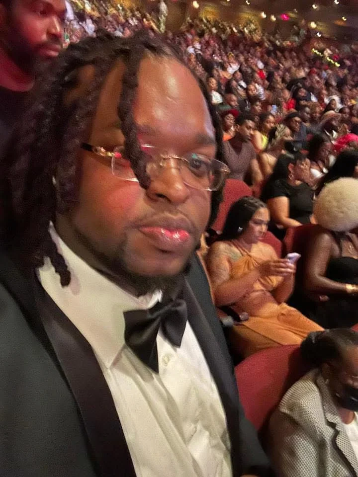 Dramma Wayne at an event in formal attire